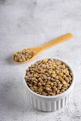 Green lentils in the bowl on the table.