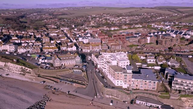 Rottingdean village in East Sussex, aerial footage of the seafront and the high street looking towards the centre of the village.