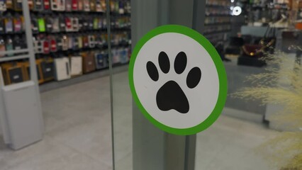 Dogs, pets allowed in a mall, green sign beckons animal companions