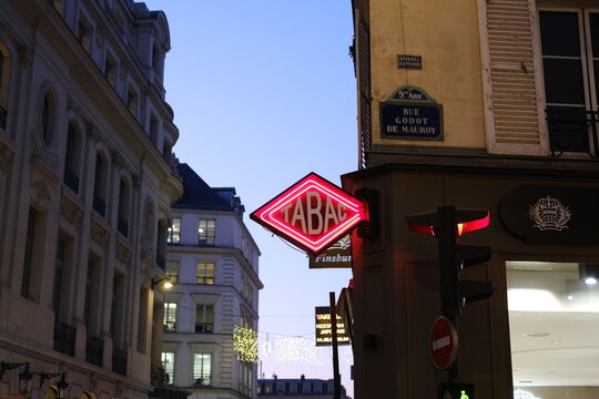 A "tabac" street sign at dusk in a Parisian street near Opera. Paris, France - January 11, 2024.