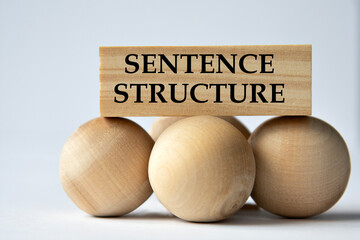 SENTENCE STRUCTURE - words on a wooden block on a white background with wooden balls - obrazy, fototapety, plakaty