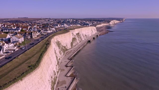 Aerial footage of the white chalk cliffs and undercliff walk at Rottingdean village in East Sussex, with Saltdean and Peacehaven in the background.