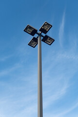 Outdoor parking lot light fixture against blue sky © Rix Pix