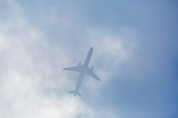 Fototapeta na wymiar Passenger plane passing through the clouds