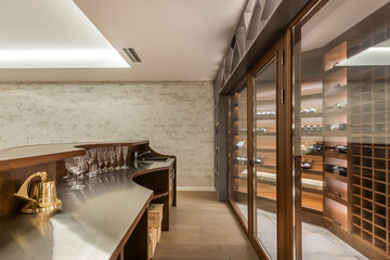 A special room in a private house with a collection of wines and a bar counter.