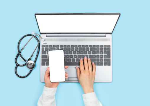 Female doctor's hands holding smartphone with blank screen and using laptop with empty monitor on blue background. Telemedicine concept