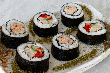 Homemade tuna futomaki maki sushi roll with Umibudo seaweed.