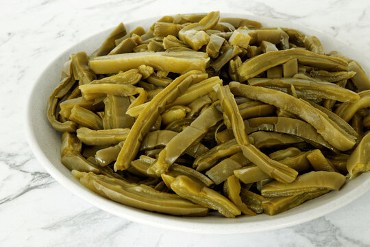 Nopales canned sliced cactus on a plate. Mexican cuisine ingredient.