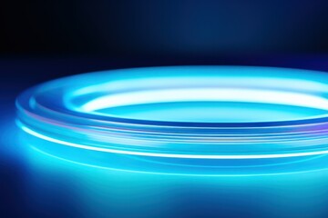 Illuminated blue podium with a glowing halo on dark background.