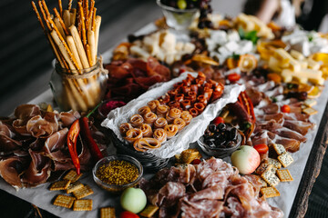 Gourmet charcuterie board filled with an assortment of meats, cheeses, and accompaniments.