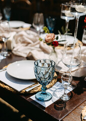 Elegant table setting with a blue crystal glass.