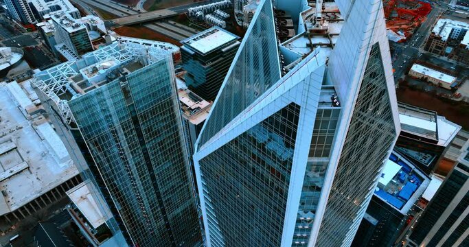 Rising over the pointed top of beautiful skyscrapers with mirror windows. Downtown of Charlotte, North Carolina, USA from air.