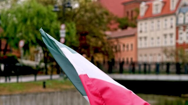 Mexican National Flag Flutters On A Flagpole On A City Street