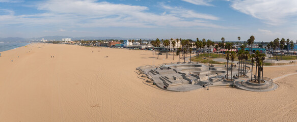 Skate board park in Venice beach with people skating by the Pacific ocean. Best and most popular...
