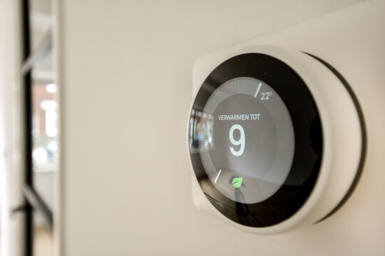 Modern Smart Thermostat Displaying Temperature Settings
