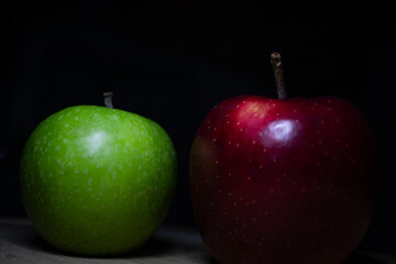 red and green apples on black