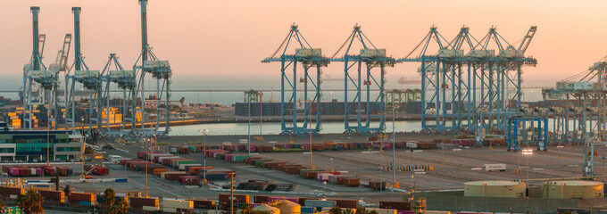 Thousands of shipping containers in the port of Long Beach near Los Angeles California. The Port of Long Beach in southern California during sunset.