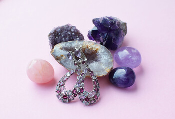 Beautiful earrings with multi-colored precious stones with amethyst and rose quartz crystals