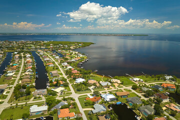 Aerial view of residential suburbs with private homes located on gulf coast near wildlife wetlands...