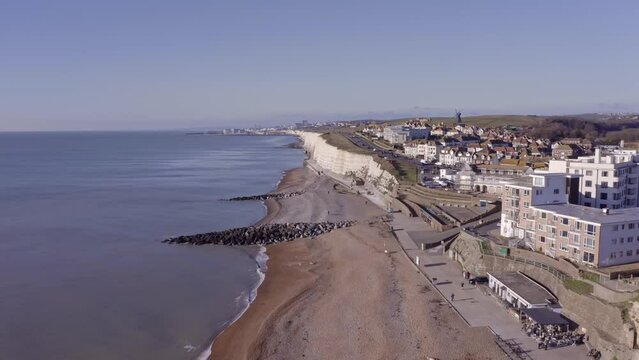 Rottingdean village in East Sussex, aerial footage along the seafront and the white chalk cliffs heading towards Brighton.