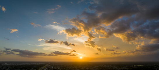 Colofrul clouds brightly illuninated by setting sun on evening sky. Changing cloudscape weather at...