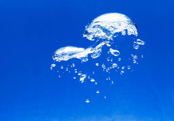 closeup, macro of white air bubbles in an aquarium, blue background