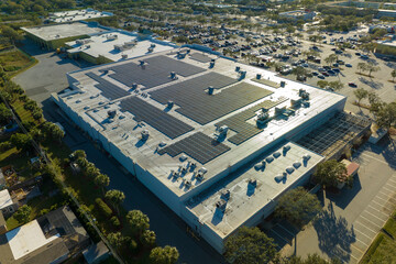 Electric photovoltaic solar panels installed on shopping mall building rooftop for production of...