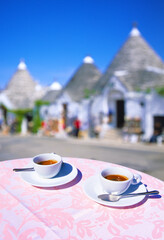 closeup of two cups of Espresso on a table, with empty street out of focus in background in...