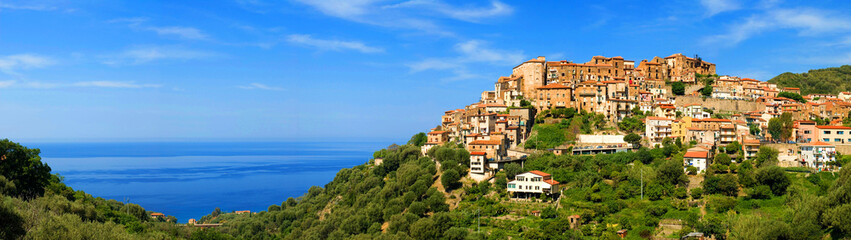 Fototapeta na wymiar panoramic panorama town view, cityscape of village Pisciotta on a hill in National Park Cilento, with mediterranean sea, blue sky, sunshine, Campania, Italy, Europe