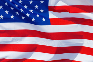 Obraz premium the national flag of the United States of America, USA, stars and stripes, flapping fluttering in the wind,