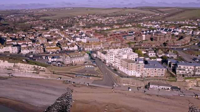 Rottingdean village in East Sussex, aerial footage along the seafront and the high street looking towards the centre of the village.