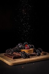 Mini Fruit Cake on Wooden Cutting Board with Cascading Sugar