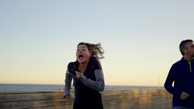 Slow motion video of a tricky mature woman prank on her husband to win running