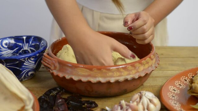 Person preparing corn dough to make tamales. Typical Mexican food.