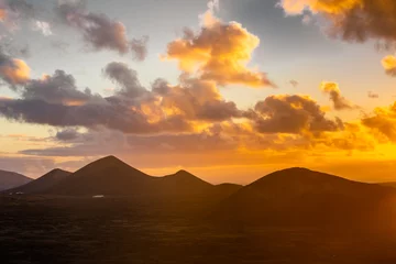 Fototapete Kanarische Inseln Amazing sunset over El Cuervo Volcano, in Lanzarote, Canary Islands,  Spain