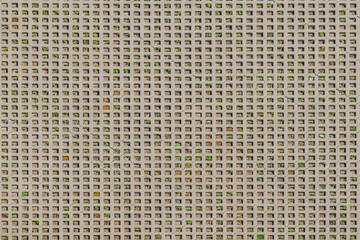 parking lot with permeable surface of concrete tiles joints filled with gravel. Abstract background. a tile with grass growing in it, a modern concrete tile. With small holes and green grass.