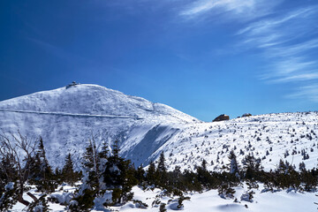 People on the trail and a tourist shelter on the top of Sniezka in the Giant Mountains
