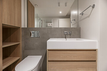 Fototapeta na wymiar A small bathroom with modern design wooden hanging furniture