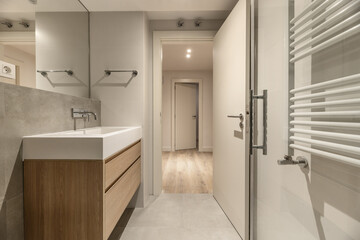 A bathroom with a modern design hanging wooden