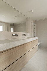 Fototapeta na wymiar Modern design bathroom with cream marble sink on wooden cabinet with drawers