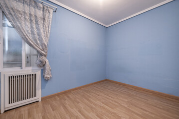 An empty room with light blue painted walls