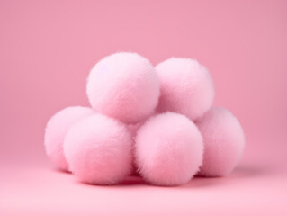 A pile of pink fluffy balls isolated on pink background