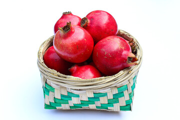 Pomegranate fruits in a bamboo basket close-up view 