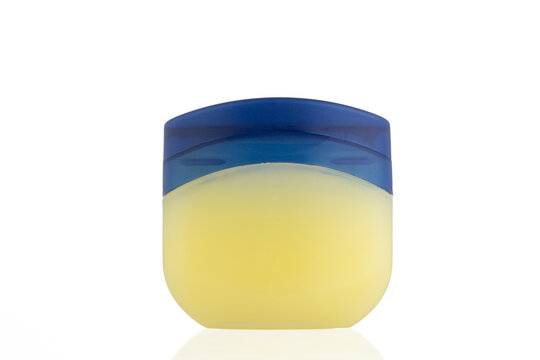 Vaseline Bottle on a white background. 
Jar for petroleum jelly. 
Yellow plastic container with blue lid.