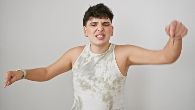Furious young man in sleeveless t-shirt, anger in his eyes, pointing accusingly at you, displeased. isolated on a stark white background, his intensity captured by the camera.