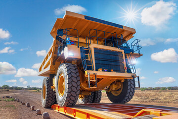 transport oversize load, loading a mining truck in a trailer to transport to a diamond mine - obrazy, fototapety, plakaty