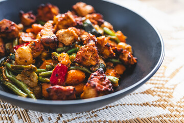 plant-based sauteed vegetables with marinated tofu chunks