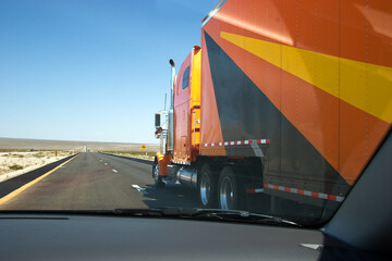 overtaking a huge lorry at the highway in desert area