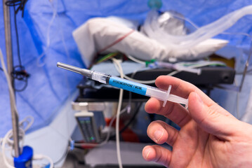 Syringes, needles, and vials of anesthesia neatly arranged on a sterile surface, symbolizing...