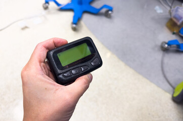 vintage pager on a busy desk, symbolizing hectic work life and essential communication in a hospital setting